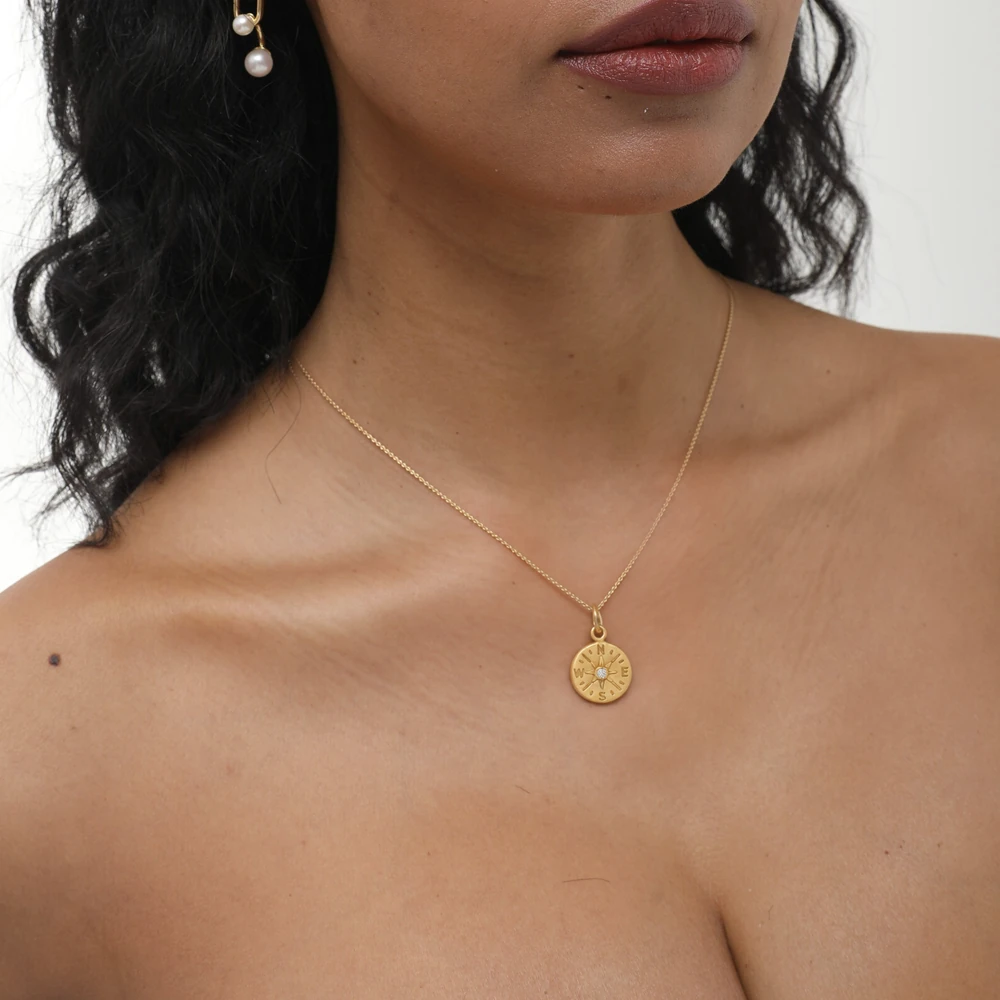 Compass Pendant | 24k gold pendant on a model