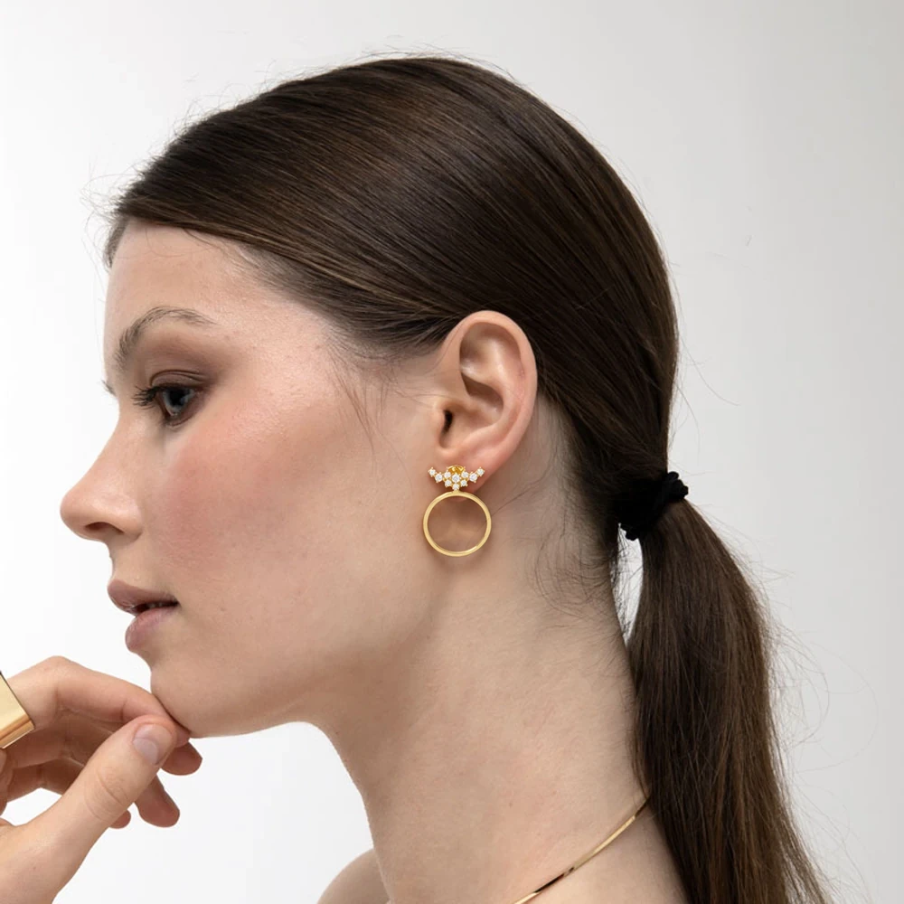 Fira Earrings | 18k gold earrings on a model