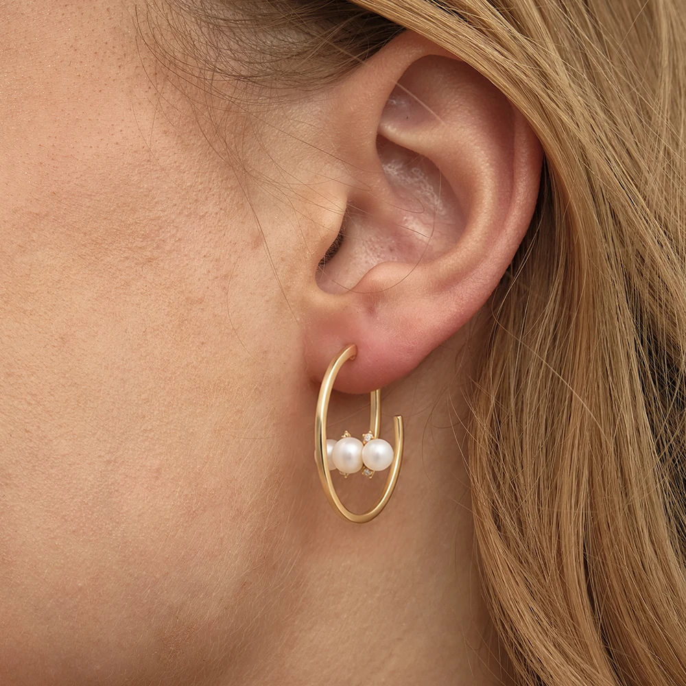 Mireya Earring | 18k gold earrings on a model, showing pearl and diamond backing